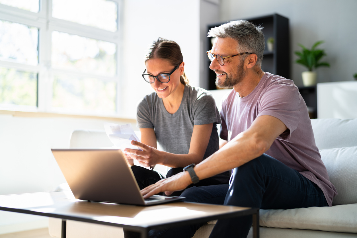 a happy couple doing their finances